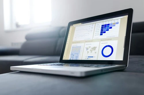A laptop with a dashboard on a desk