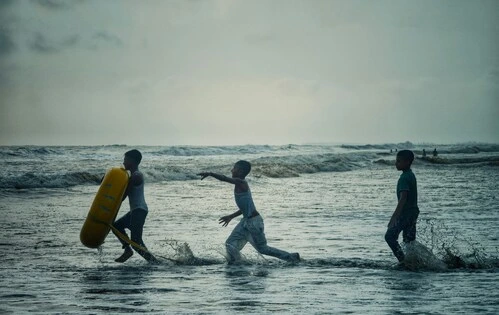 Three children running in a lake